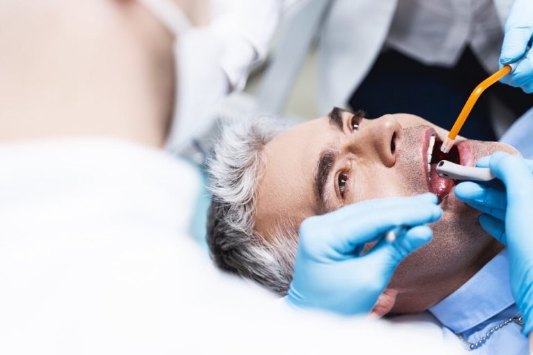 male-is-visiting-dentist-treating-cavity-being-given-filling-with-help-specialist-nurse_317809-5399.jpg